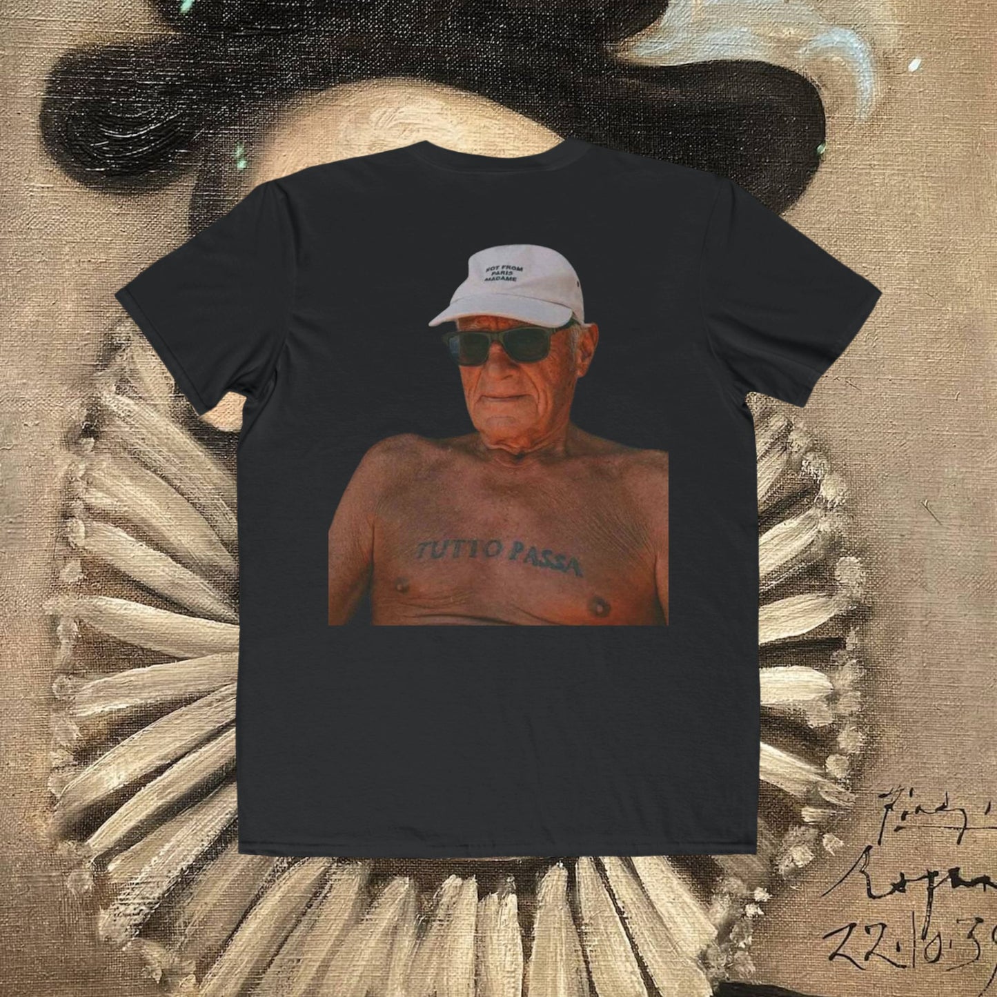 Black t-shirt with a graphic of a man wearing sunglasses and a white cap, set against a textured background.